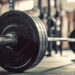Barbell on the floor in the gym. Horizontal banner for a gym.