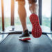 Male feet in sneakers running on the treadmill at the gym. Exercise concept.